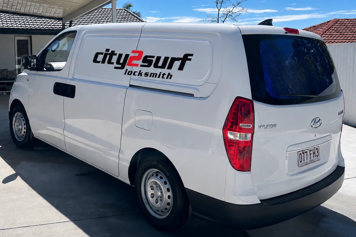 The signed City2Surf Locksmiths van parked on a Gold Coast driveway